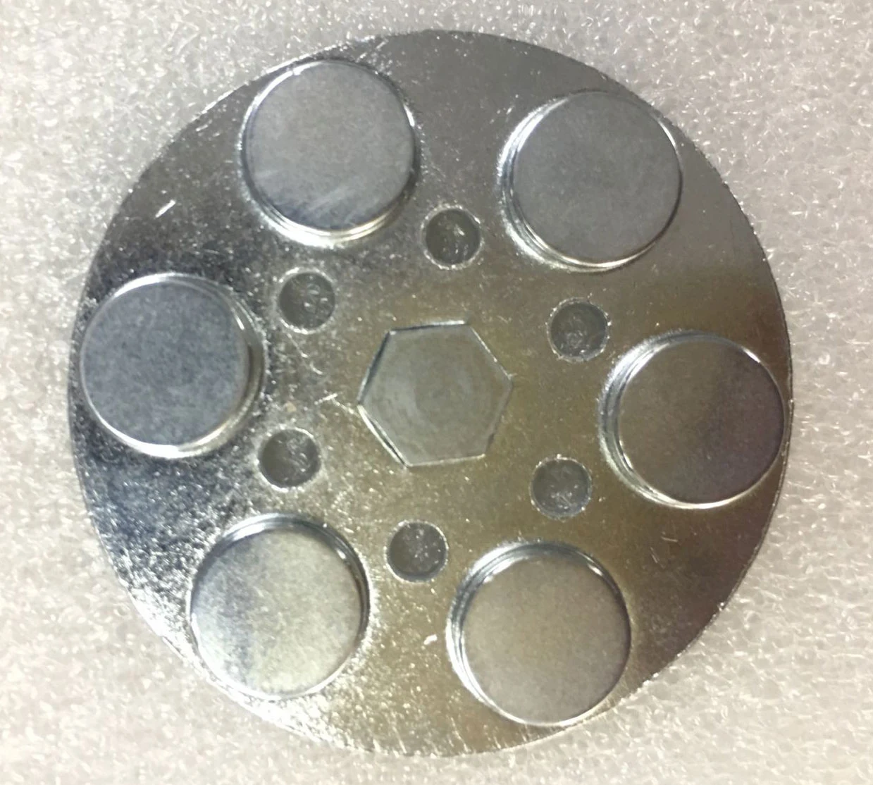 Steel carrier with multiple magnet inserts before rubber coating